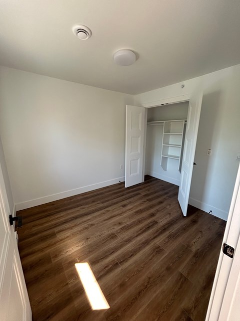A room with a wooden floor and white walls.