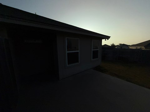A house with a sunset in the background.