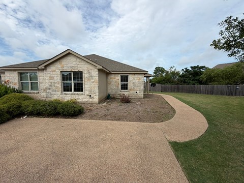 A house with a brown roof and a brown driveway.