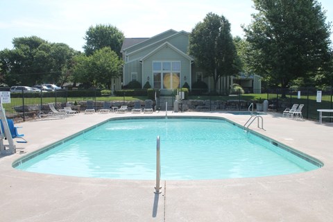 A swimming pool in front of a house.