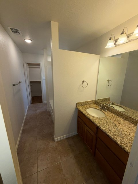 A bathroom with a sink and mirror.
