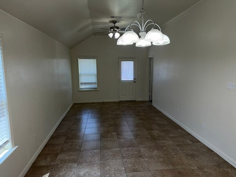 A room with a tiled floor and a ceiling fan.
