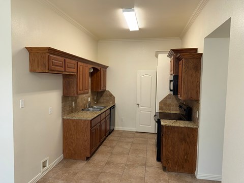 A kitchen with wooden cabinets and a countertop.