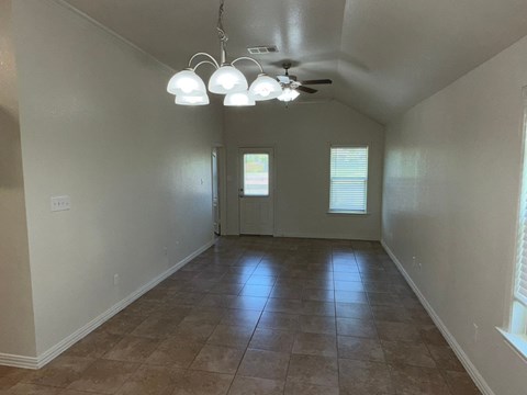 A room with a tiled floor and a ceiling fan.