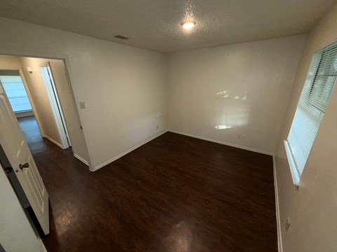 A room with wooden floors and white walls.