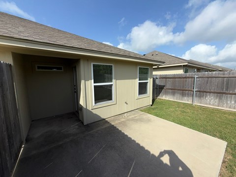A house with a brown roof and a brown fence.