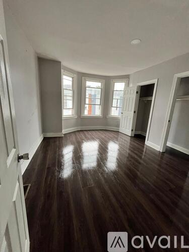 A room with wooden floors and white walls.