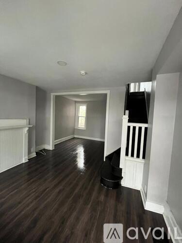A room with wooden floors and white walls.