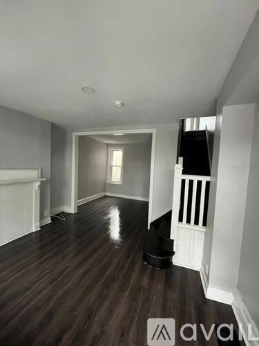 A room with wooden floors and white walls.