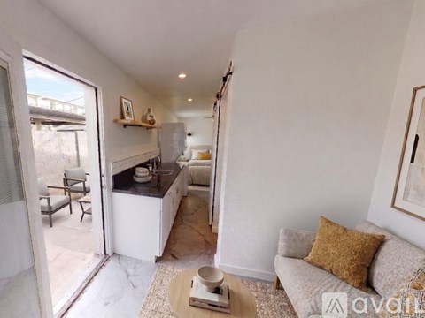 A living room with a couch and a table in the middle.