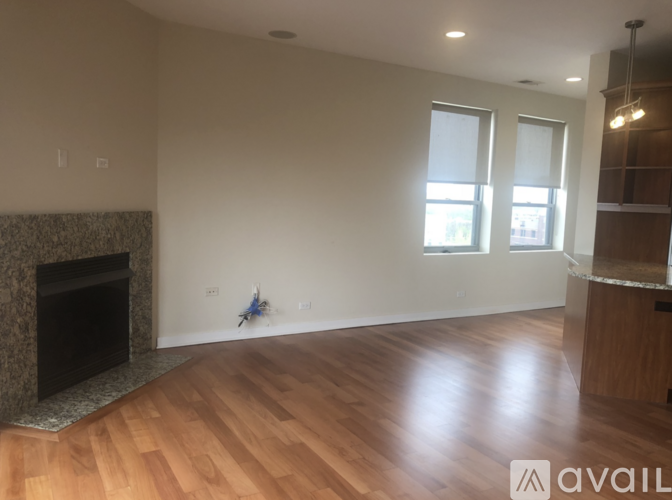 A room with a fireplace and wooden flooring.