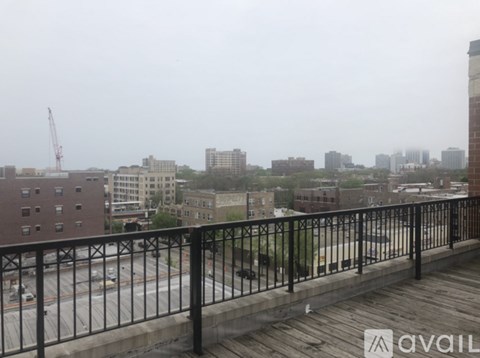A rainy day in the city with a view of the buildings and a construction crane.
