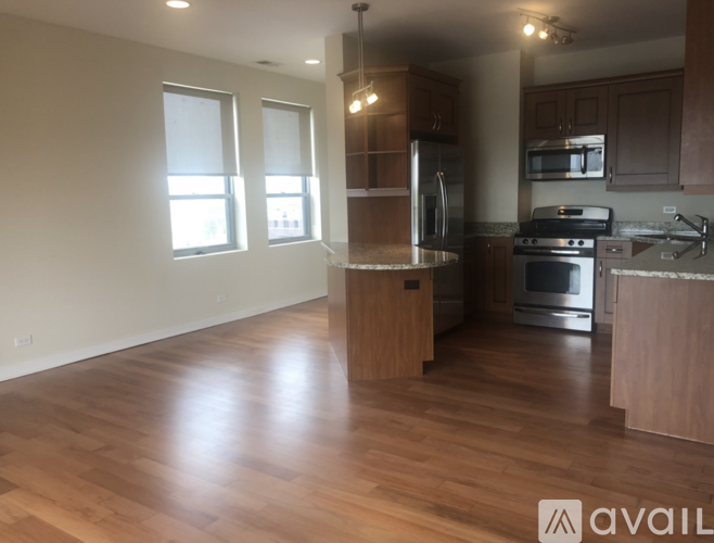 A kitchen with wooden floors and stainless steel appliances.