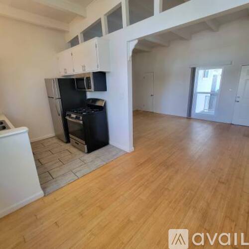 A kitchen area with a refrigerator, oven, and microwave.