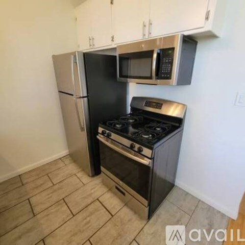A kitchen with a black stove and a black refrigerator.