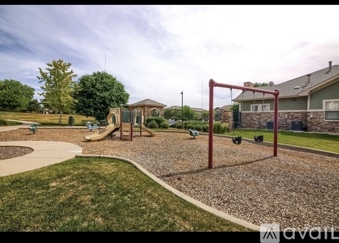 A playground with a swing set and a slide.