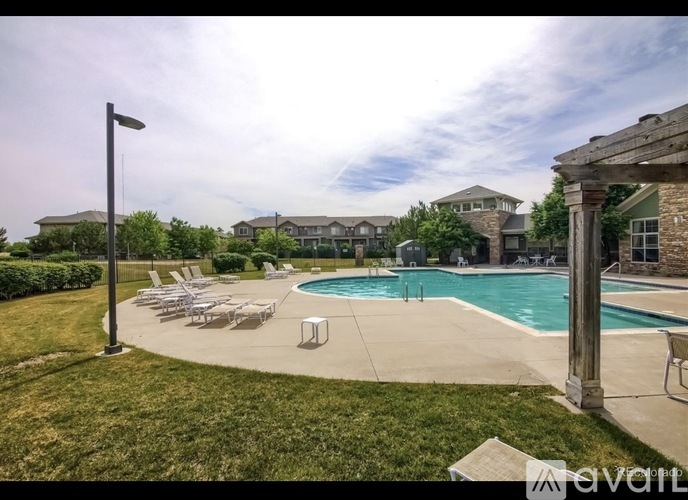 A pool area with a lawn and a lamp post.
