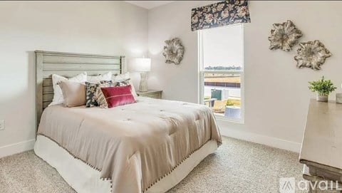 A bedroom with a large bed and a window with a view of the outside.