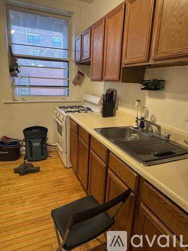 A kitchen with wooden cabinets and a window.