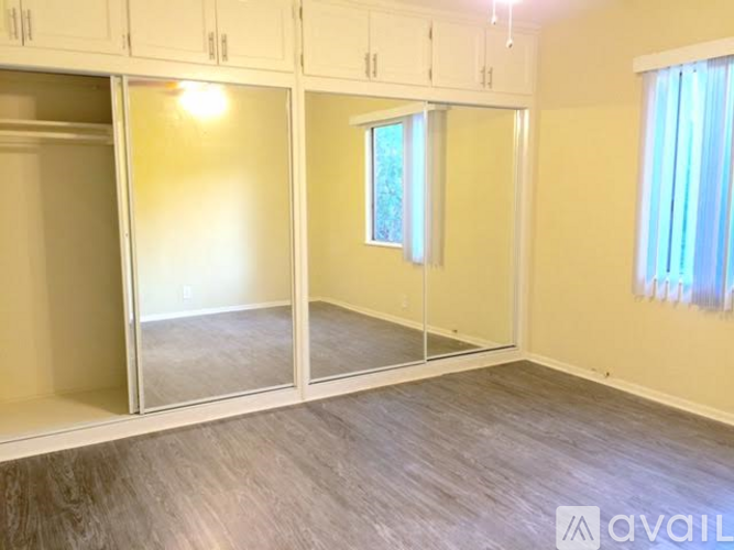 A room with a glass door and a window with a white frame.