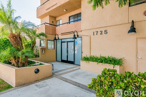A building with the number 1725 on it has a balcony and a door.