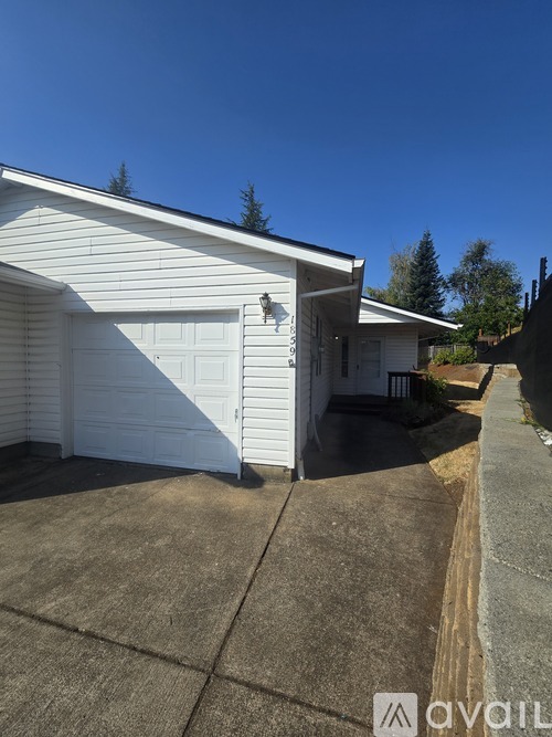 A white house with a closed garage door.