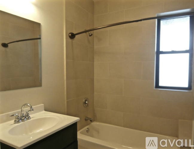 A bathroom with a white sink and a bathtub.