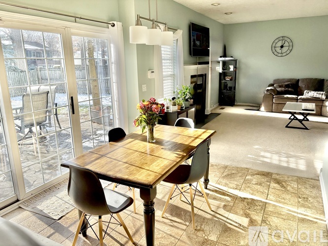 A dining room with a table and chairs is shown.
