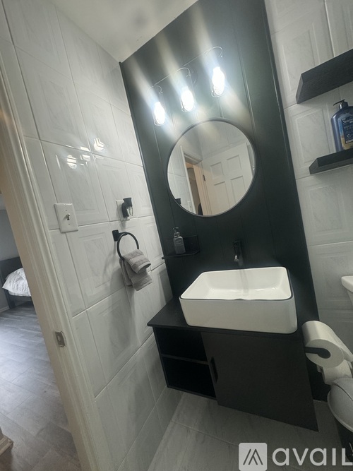 A bathroom with a sink and mirror.
