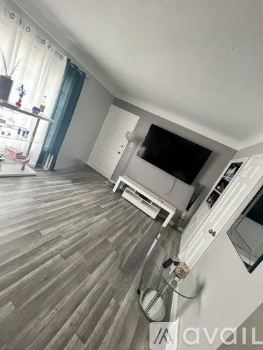 A living room with a television and a cabinet.