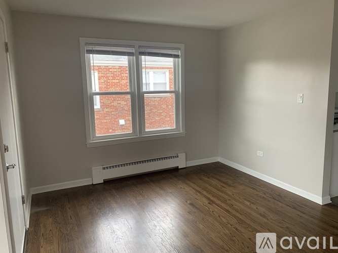 A room with a window and a radiator on the wall.