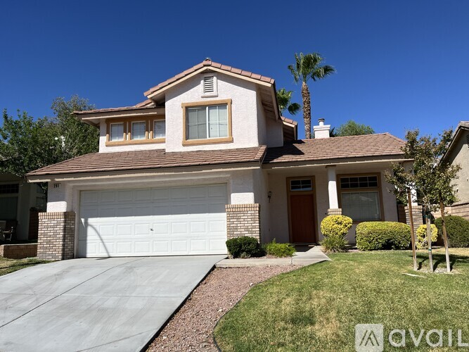 A house with a garage and a driveway in front.
