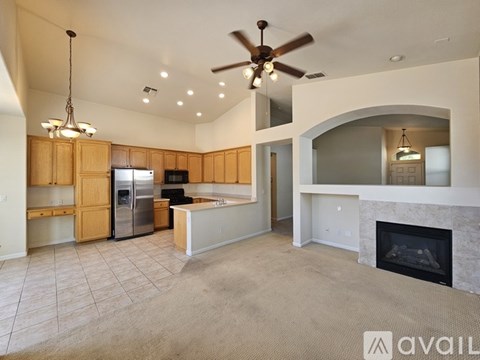 A spacious kitchen with wooden cabinets and a fireplace.