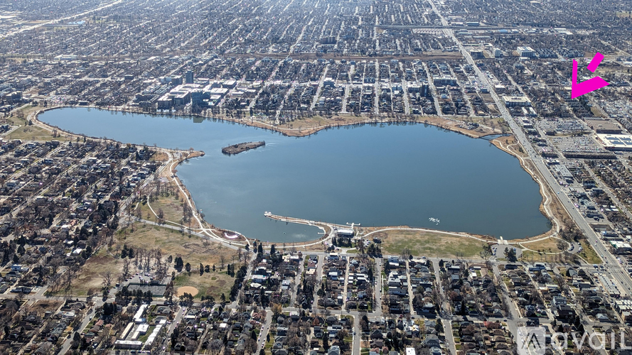 An aerial view of a city with a large lake in the center.