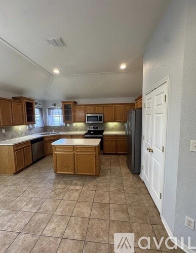 A kitchen with wooden cabinets and a white countertop.
