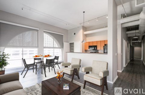 A living room with a dining table and chairs.