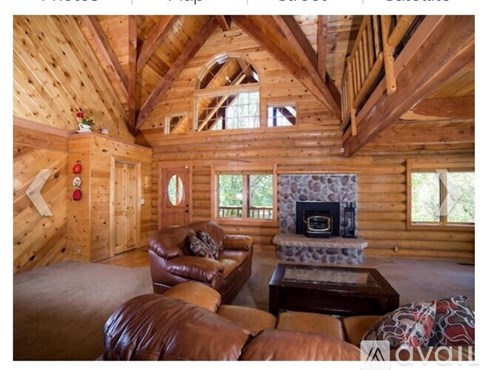A cozy living room with a fireplace and leather furniture.
