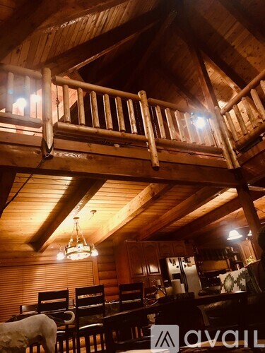 A wooden balcony with a table and chairs is visible from the dining room.