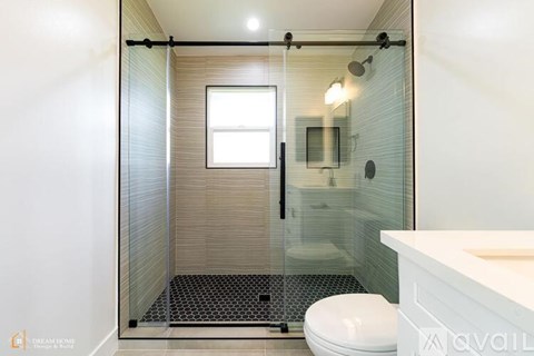 A room with a white wall and a wooden floor.