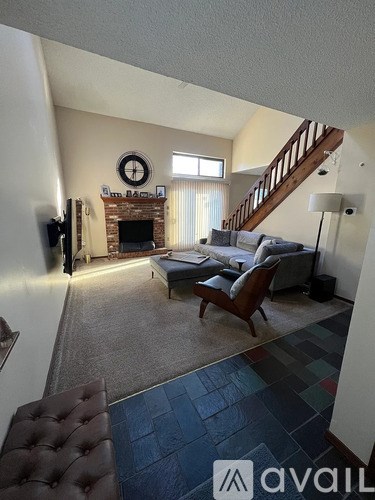 A living room with a brown leather chair and a brown wooden chair.