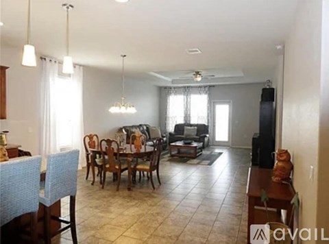 A living room with a dining table and chairs.