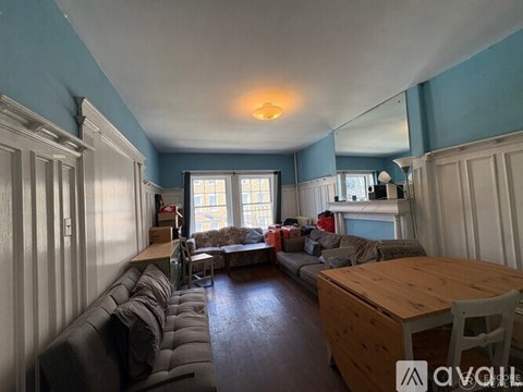 A living room with a grey couch and a wooden table.