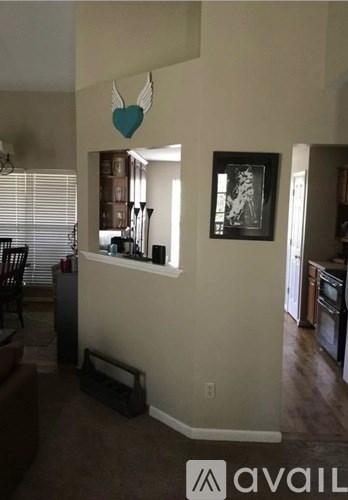 A living room with a heart-shaped decoration hanging from the ceiling.