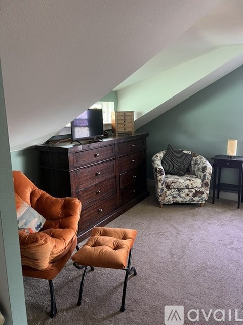 A living room with a chair and a sofa.