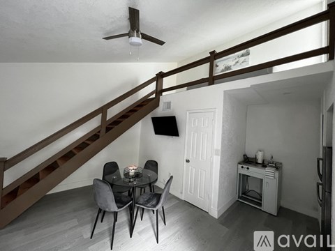 A dining room with a table and chairs is shown.