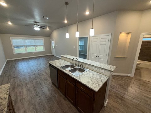 A kitchen with a sink and a window.