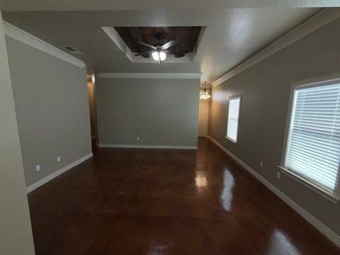 A room with wooden floors and a ceiling fan.
