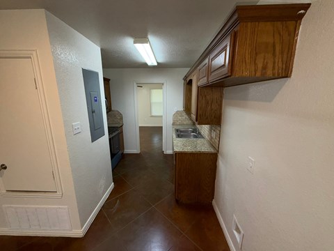 A kitchen area with a sink and cabinets.