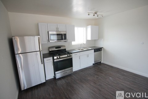A kitchen with white cabinets and stainless steel appliances.