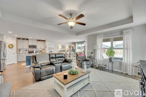 A living room with a grey sofa and a wooden coffee table.